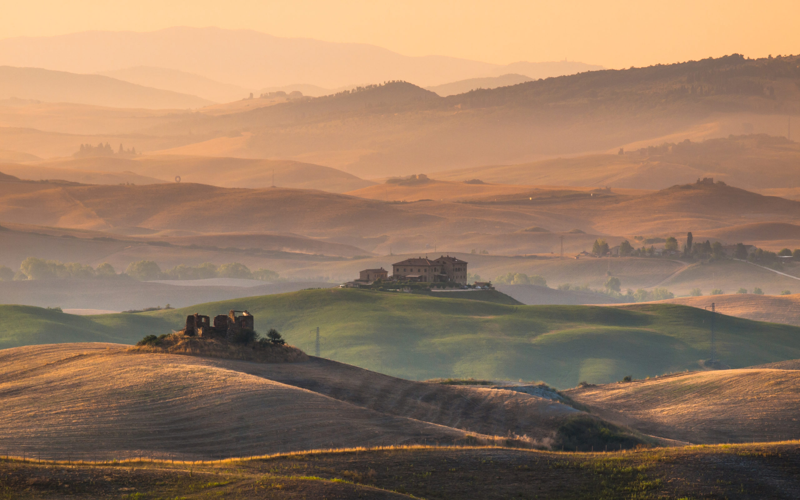 Sunrise over Farms in Hilly Countryside in Tuscany, Italy